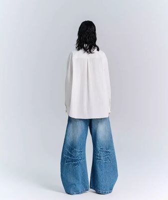 Jeans a gambe larghe di tessuto denim decostruito per uomini e donne in abbigliamento da strada in taglia più grande